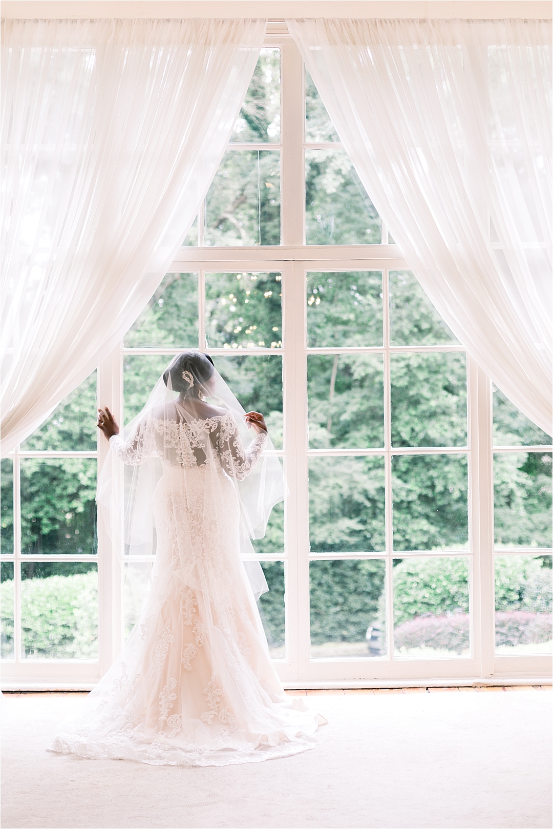bride in dress and veil at window_Photos by Leigh Wolfe, Atlanta's Top Wedding Photographer