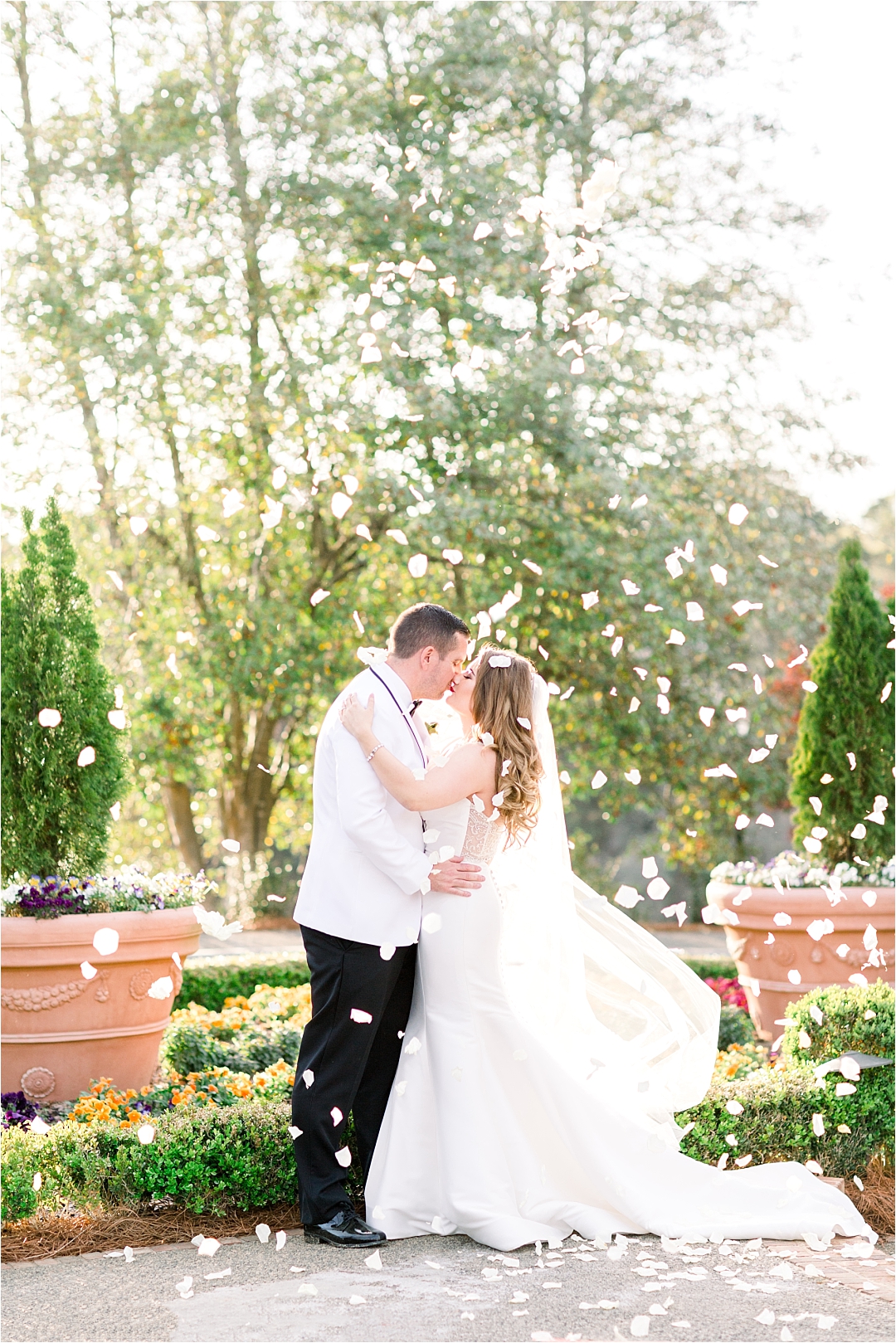 bride and groom under flower petals_Photos by Leigh Wolfe, Atlanta's Top Wedding Photographer