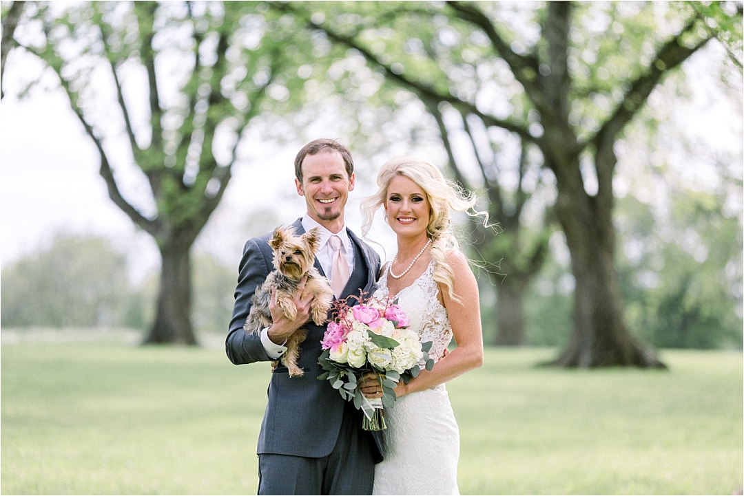couple holding dog on wedding day_Photos by Leigh Wolfe, Atlanta's Top Wedding Photographer