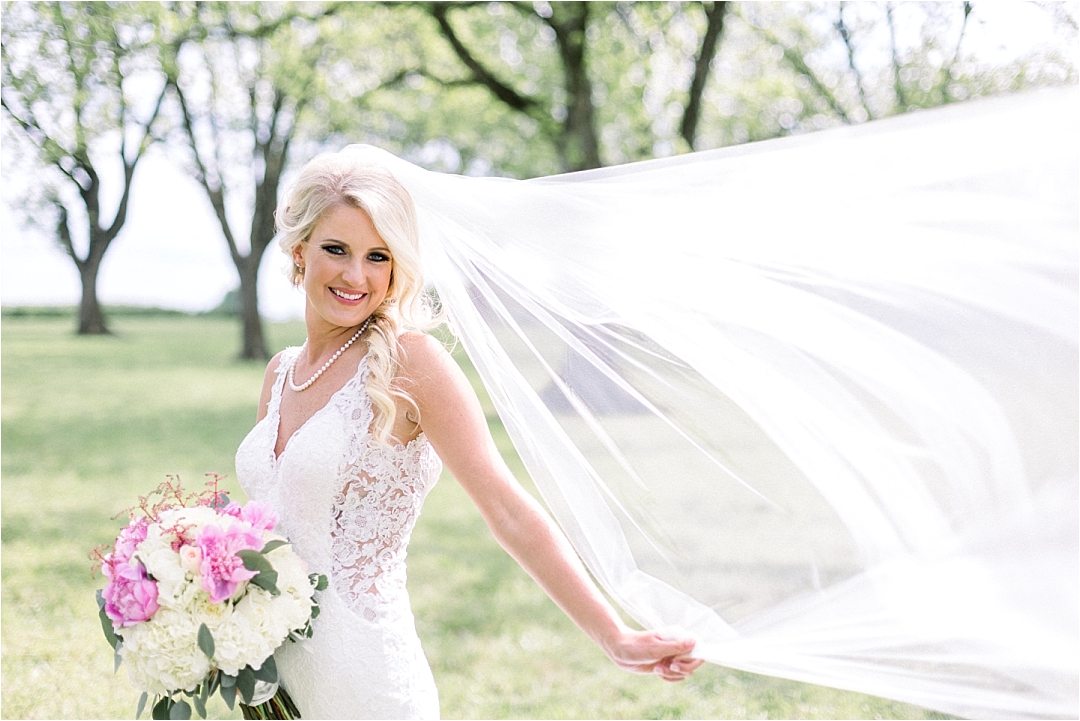 windswept bride with blush flowers_Photos by Leigh Wolfe, Atlanta's Top Wedding Photographer