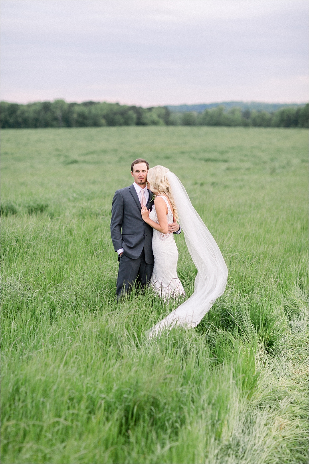 bride with epic veil in field_Photos by Leigh Wolfe, Atlanta's Top Wedding Photographer