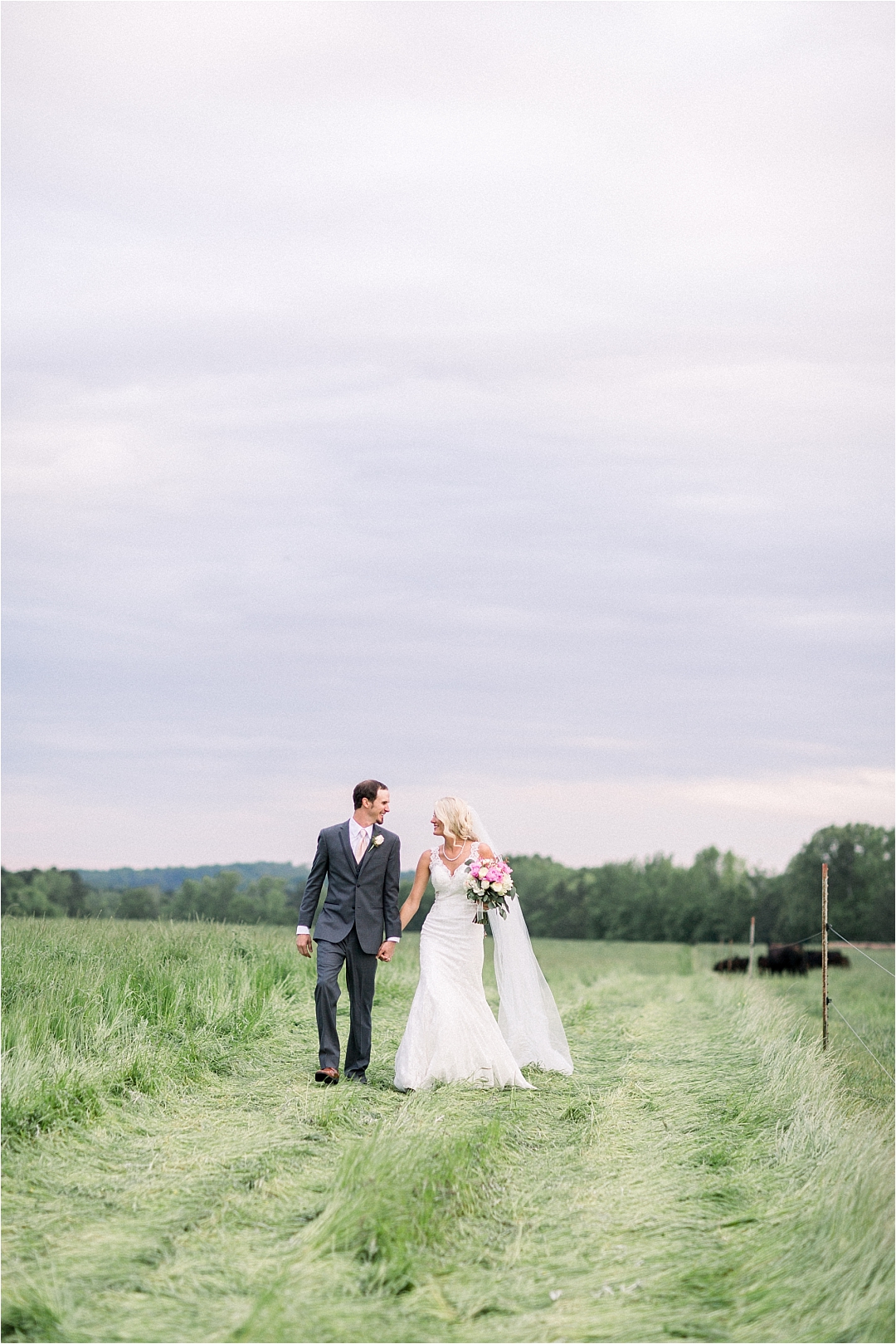 couple walking down dirt road_Photos by Leigh Wolfe, Atlanta's Top Wedding Photographer