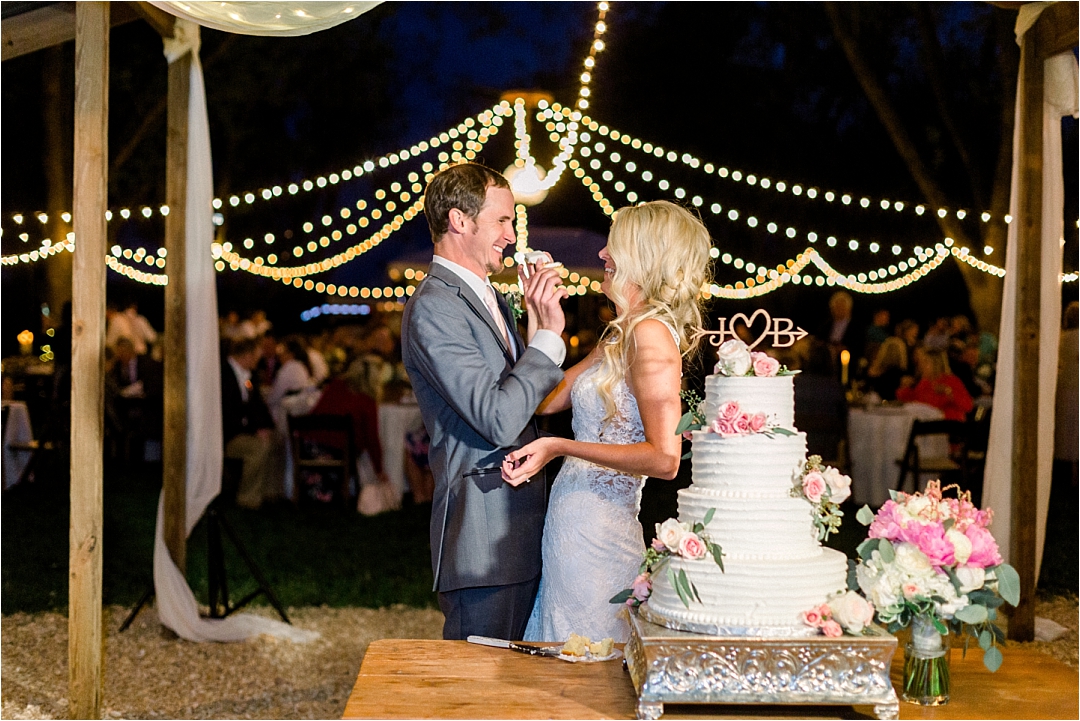 couple feeding eachother cake at reception_Photos by Leigh Wolfe, Atlanta's Top Wedding Photographer