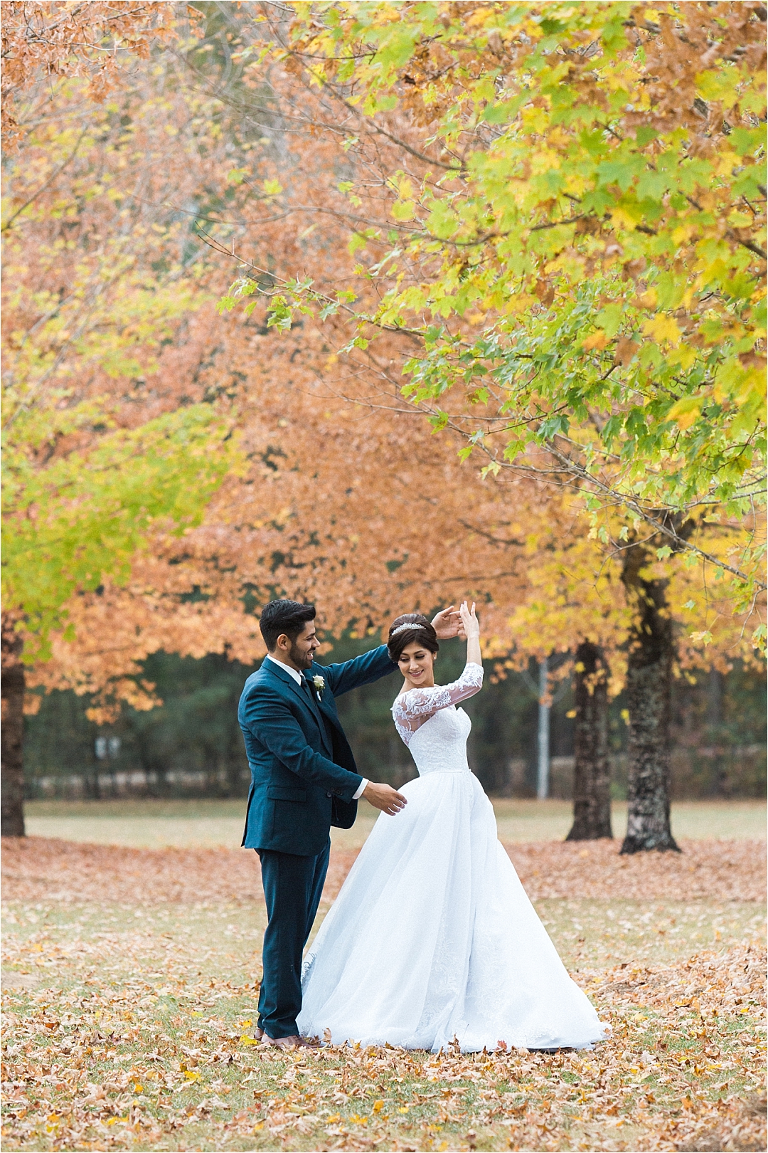 groom spinning bride in fall leaves_Photos by Leigh Wolfe, Atlanta's Top Wedding Photographer