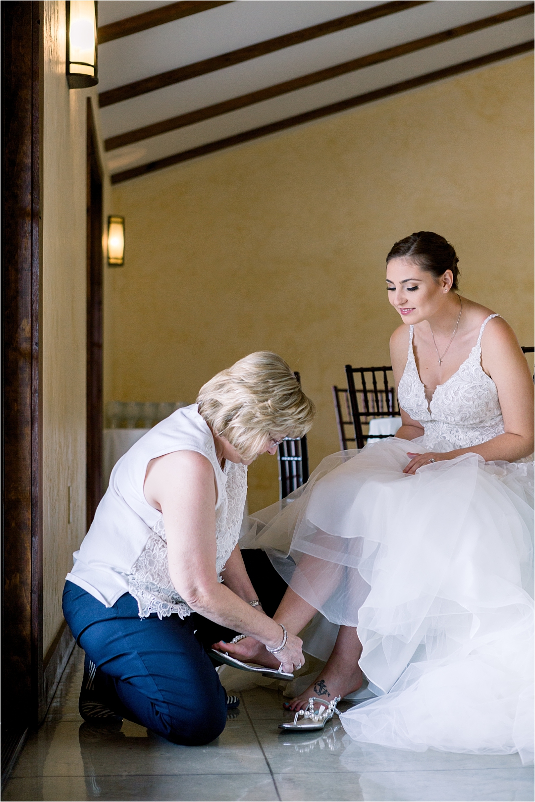 mother of the bride helping her put on shoes_Photos by Leigh Wolfe, Atlanta's Top Wedding Photographer
