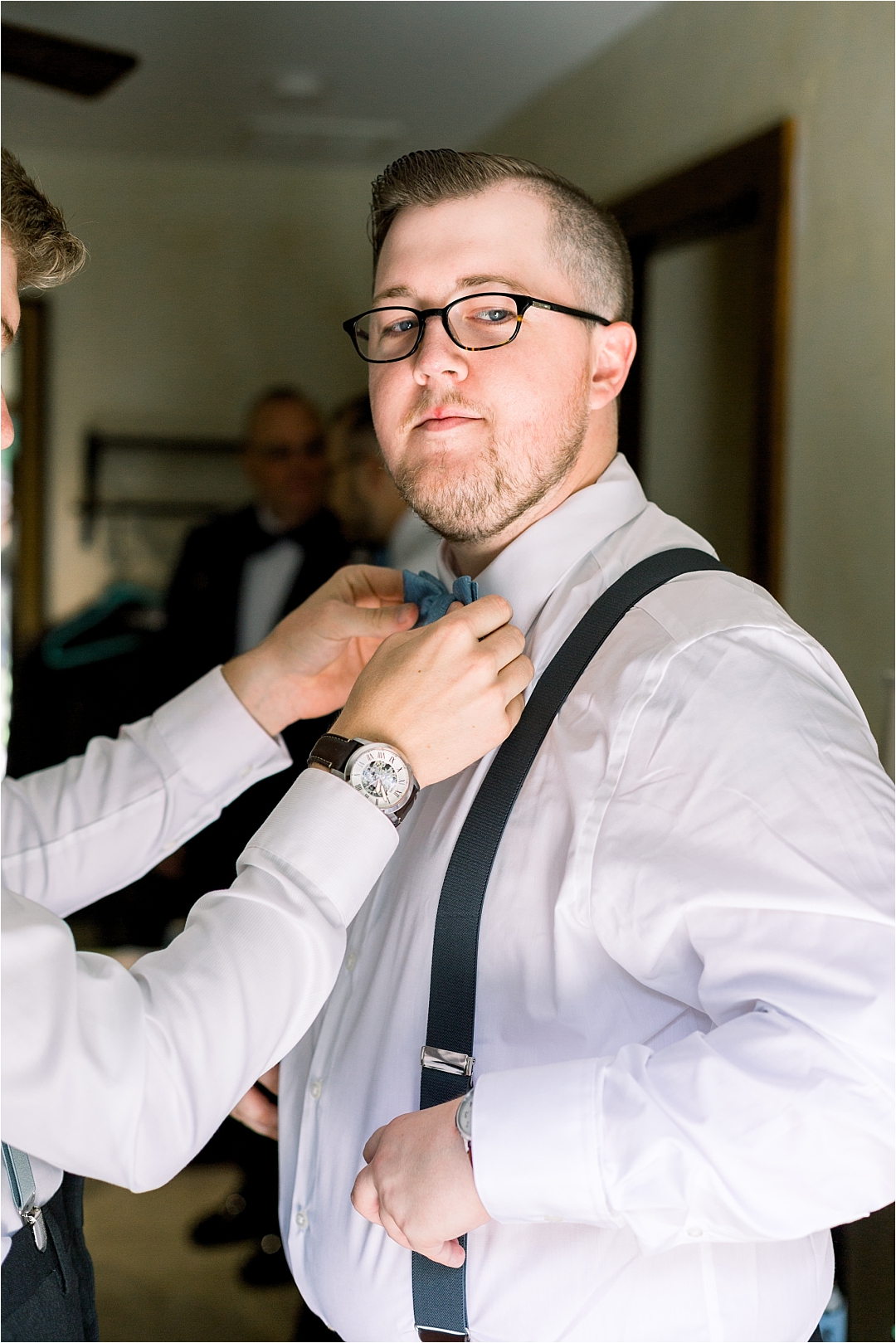 groom getting bowtie tied_Photos by Leigh Wolfe, Atlanta's Top Wedding Photographer