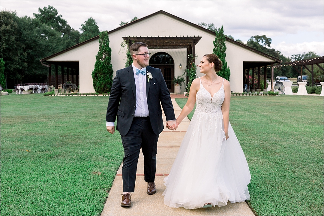 bride and groom walking near venue_Photos by Leigh Wolfe, Atlanta's Top Wedding Photographer