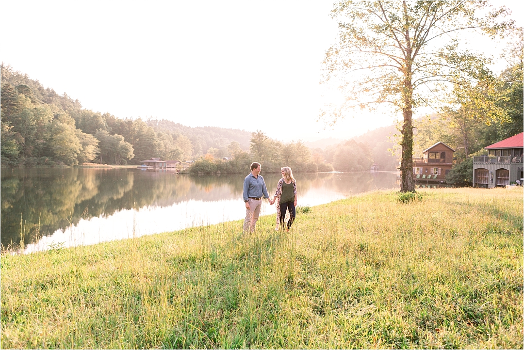 couple in love standing by lake in tall grass_Photos by Leigh Wolfe, Atlanta's Top Wedding Photographer