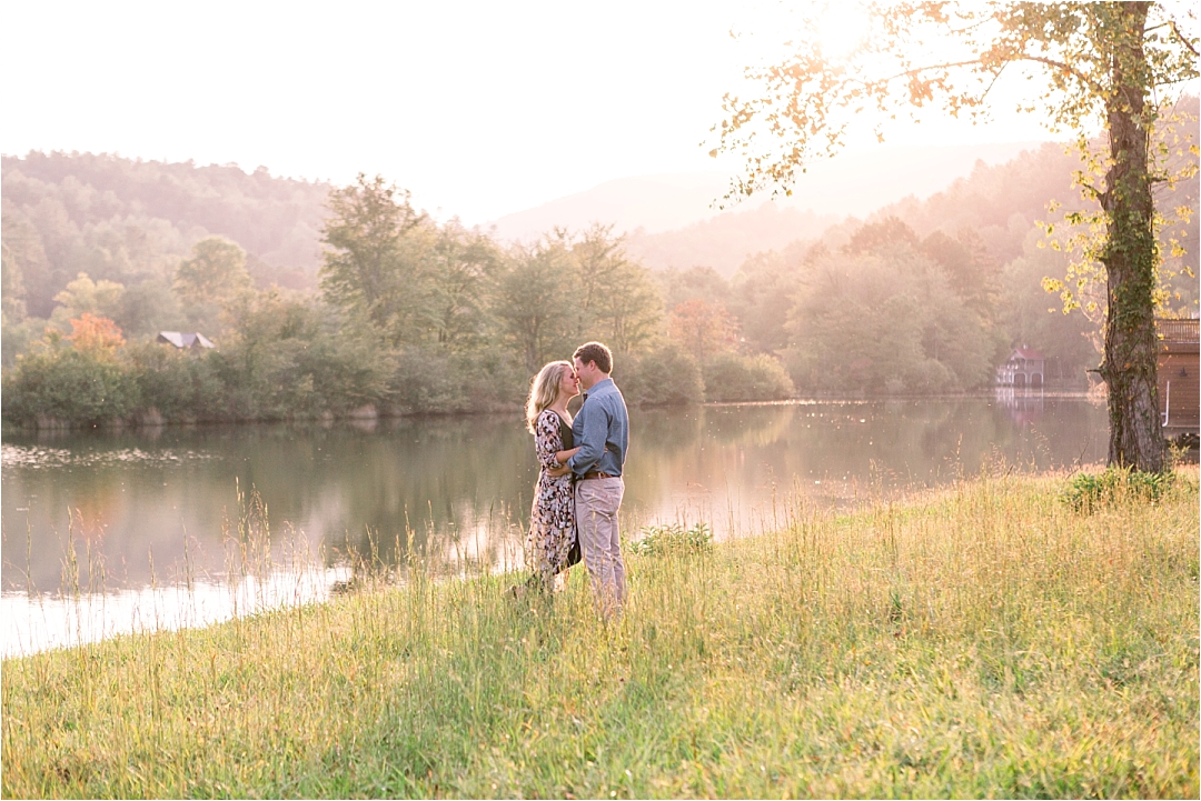 couple kissing by lake at golden hour_Photos by Leigh Wolfe, Atlanta's Top Wedding Photographer