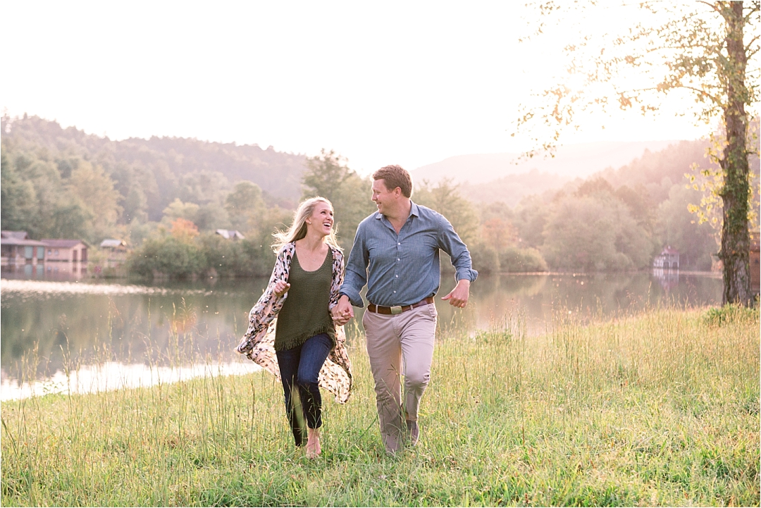 couple running through field in mountains at golden hour_Photos by Leigh Wolfe, Atlanta's Top Wedding Photographer
