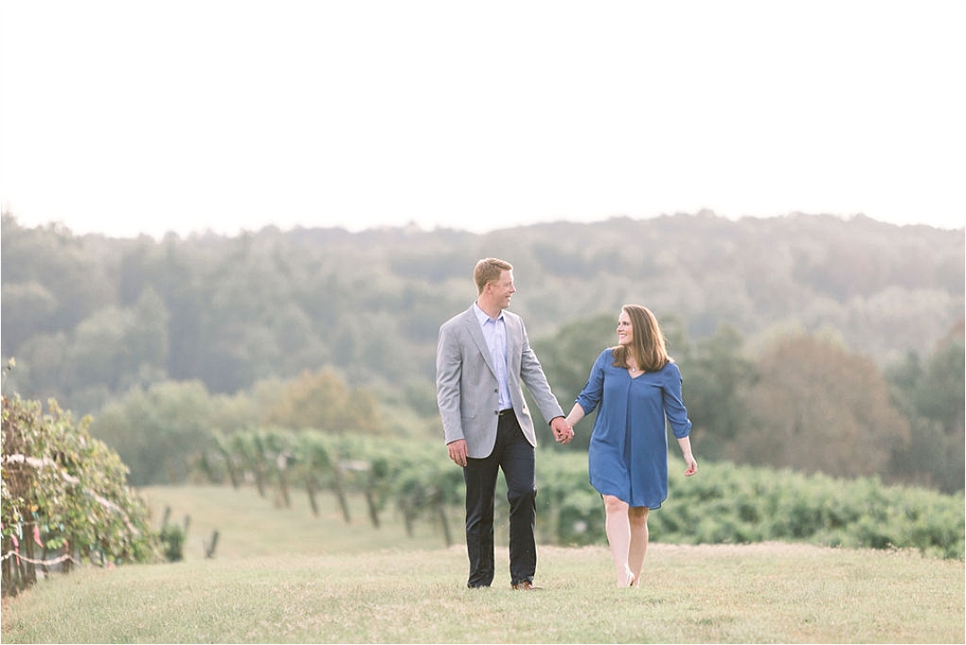 walking hand in hand through vineyard+