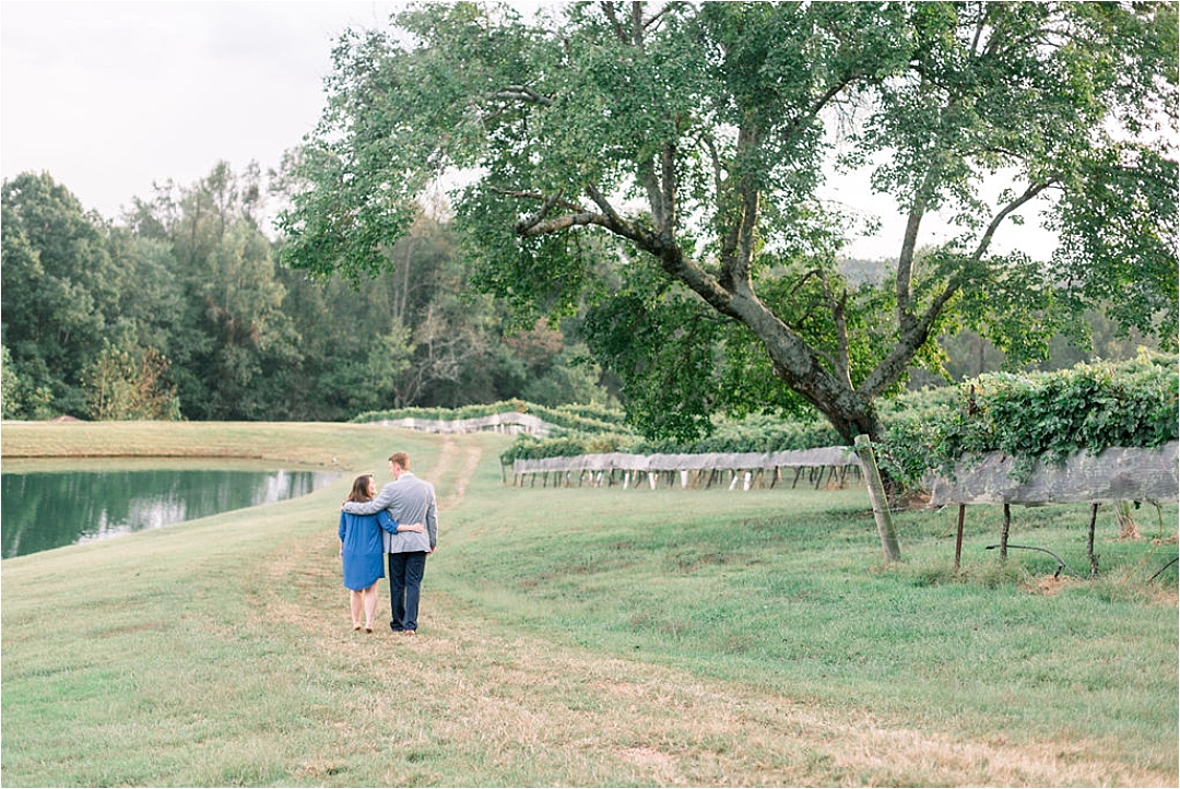 couple walking alongside lake_Photos by Leigh Wolfe, Atlanta's Top Wedding Photographer