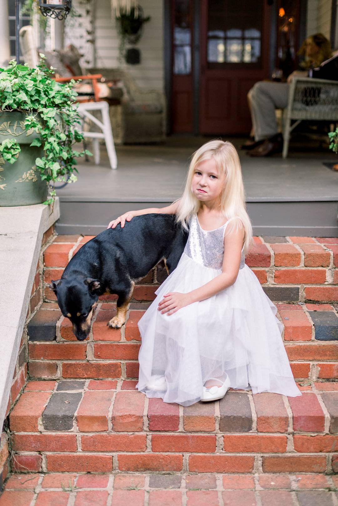 Pup and flower girl make silly faces before the wedding. 
