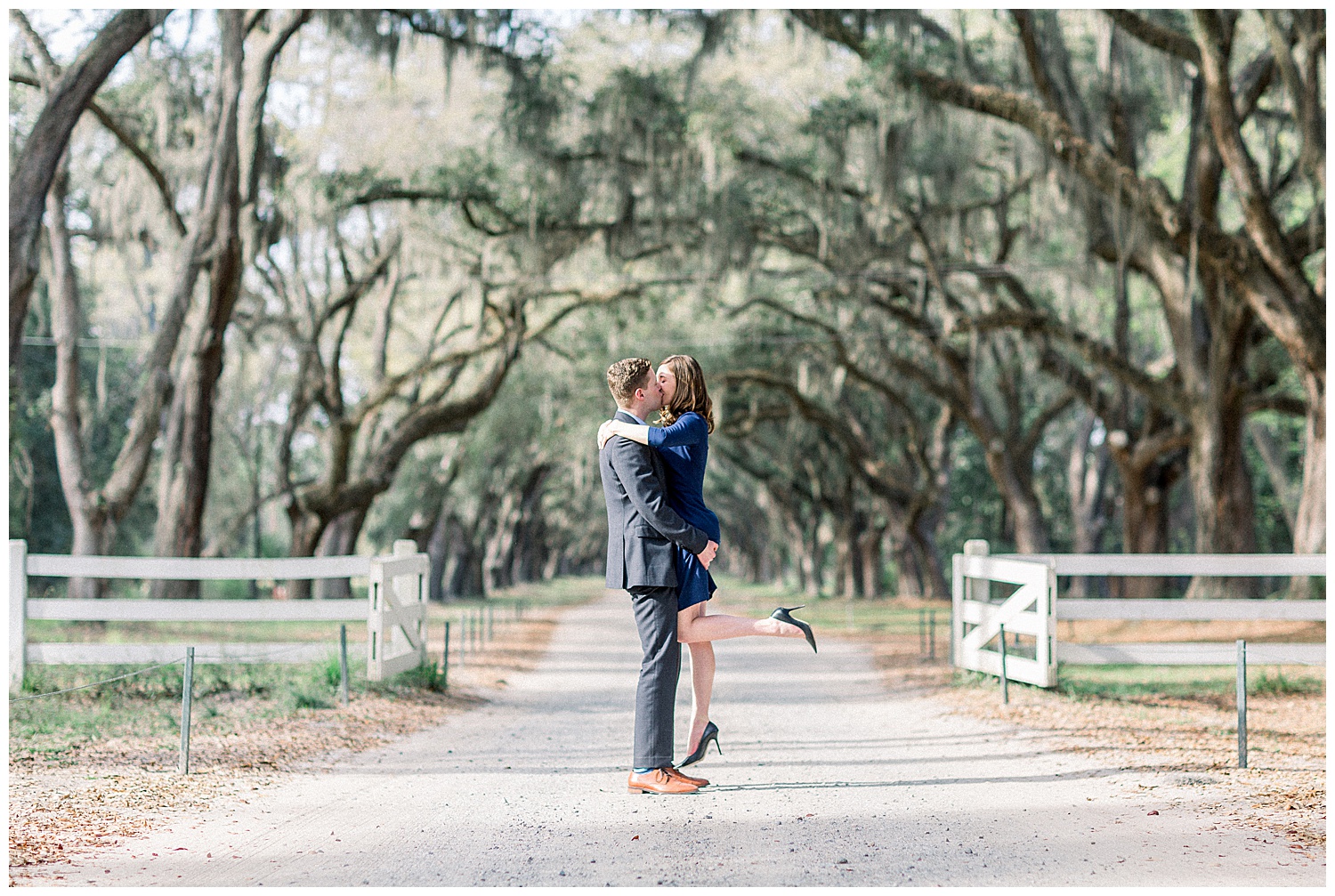 Engagement photo of couple kissing under Spanish moss in Savannah, Georgia