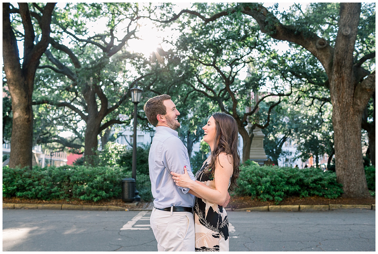 Engaged couple embracing on a Savannah, Georgia street.